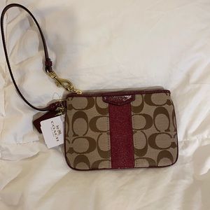 New w/ Tags Coach Wristlet. “C” logo design and burgundy detailing. 4” x 6”